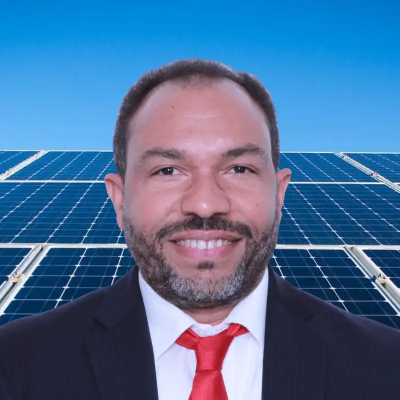 person standing in front of a solar panel and a blue sky shining bright in the back